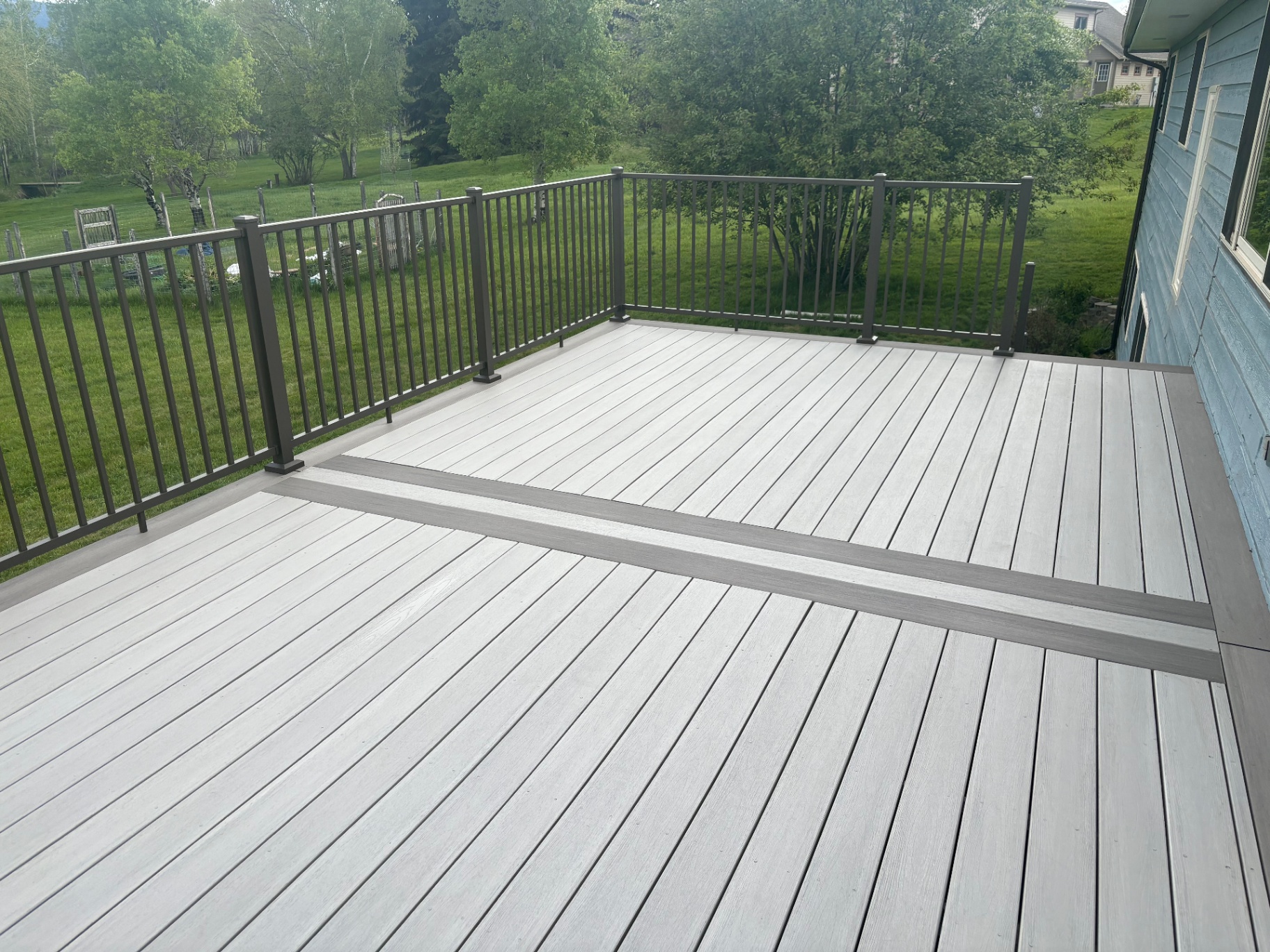 Elevated composite deck with metal railing — New Decks project in Shreveport by ARK LA TEX Entreprises